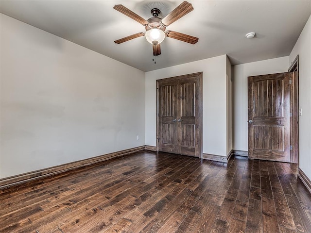 unfurnished bedroom with ceiling fan, a closet, wood-type flooring, and baseboards