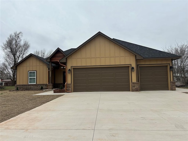 view of front of house featuring brick siding, a shingled roof, concrete driveway, an attached garage, and board and batten siding