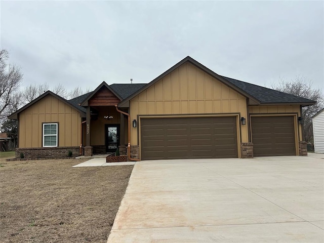 view of front of home with board and batten siding, brick siding, driveway, and a garage