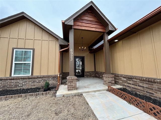 property entrance featuring brick siding and board and batten siding