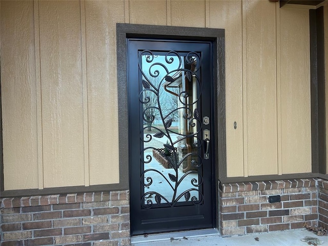 view of exterior entry with brick siding