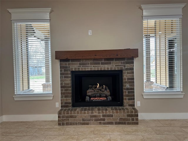 details featuring a brick fireplace and baseboards