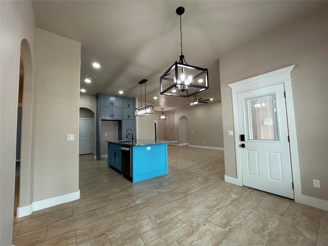 kitchen with a ceiling fan, arched walkways, open floor plan, and a sink