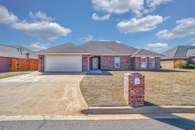 ranch-style house featuring a garage, driveway, roof with shingles, fence, and brick siding