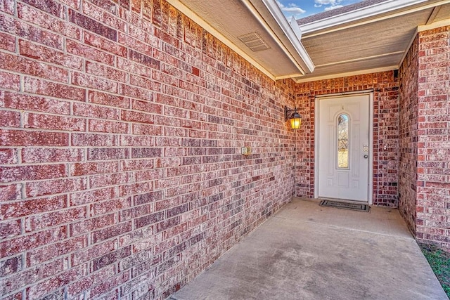 entrance to property with brick siding