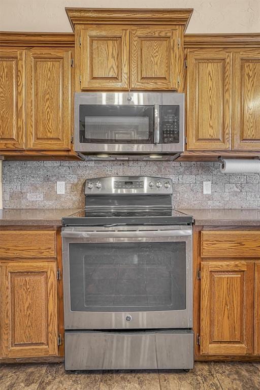 kitchen with stainless steel appliances, brown cabinets, and decorative backsplash