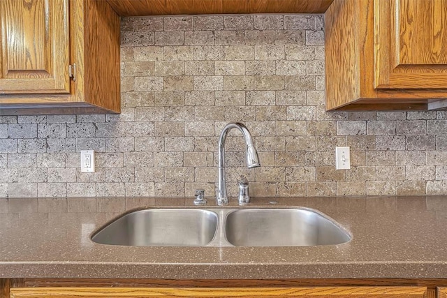 kitchen with wooden ceiling, brown cabinets, and a sink