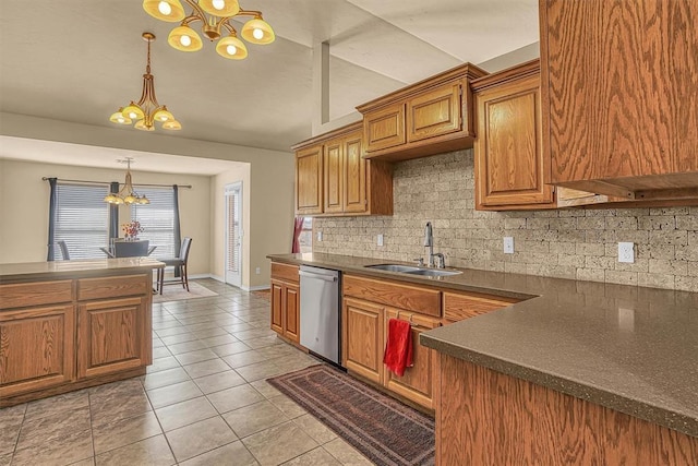 kitchen featuring light tile patterned floors, a sink, dishwasher, dark countertops, and an inviting chandelier