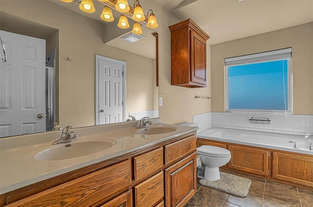 bathroom with double vanity, visible vents, a sink, and a bath