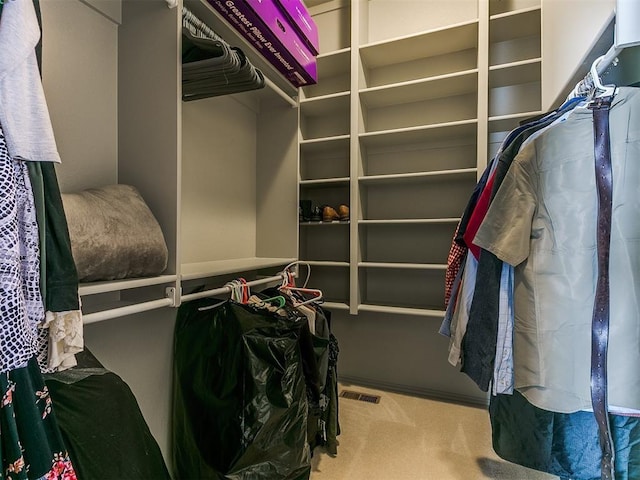 walk in closet with carpet floors and visible vents