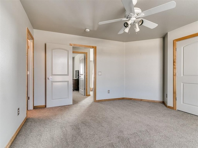 unfurnished bedroom featuring ceiling fan, carpet, and baseboards