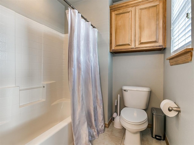 bathroom featuring toilet, baseboards, shower / bath combination with curtain, and tile patterned floors