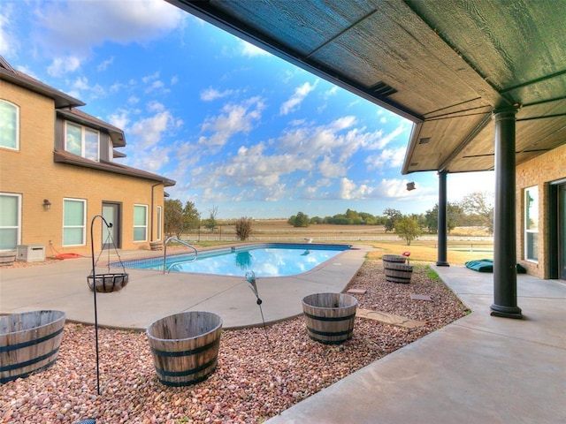 view of swimming pool with a fenced in pool and a patio