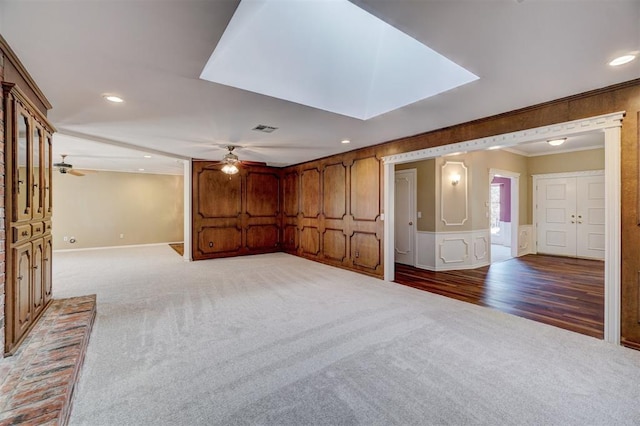 unfurnished room with light carpet, ornamental molding, visible vents, and ceiling fan