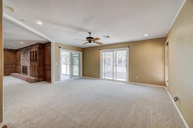 unfurnished living room with a ceiling fan, baseboards, recessed lighting, ornamental molding, and carpet flooring