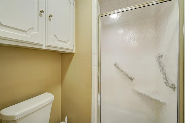 full bathroom with toilet and a shower stall