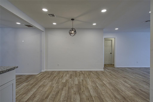 unfurnished dining area featuring baseboards, recessed lighting, visible vents, and light wood-style floors