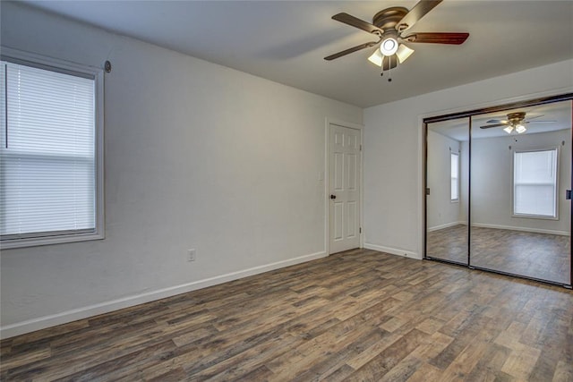 unfurnished bedroom featuring a closet, ceiling fan, baseboards, and wood finished floors