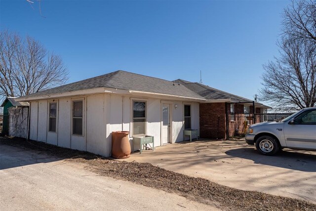 exterior space with roof with shingles