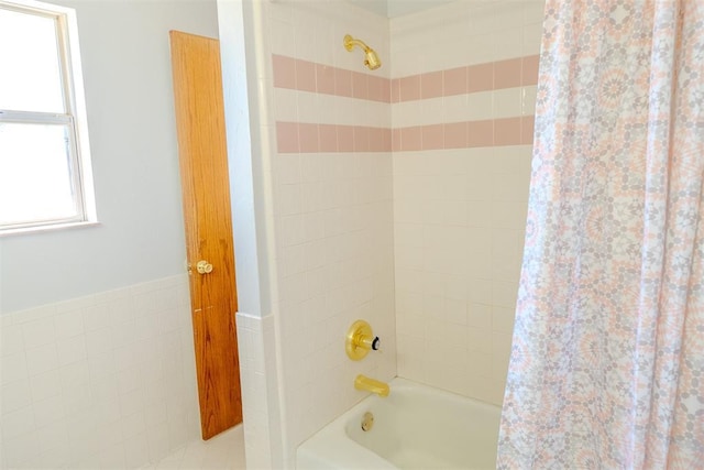 full bathroom with shower / bath combo with shower curtain