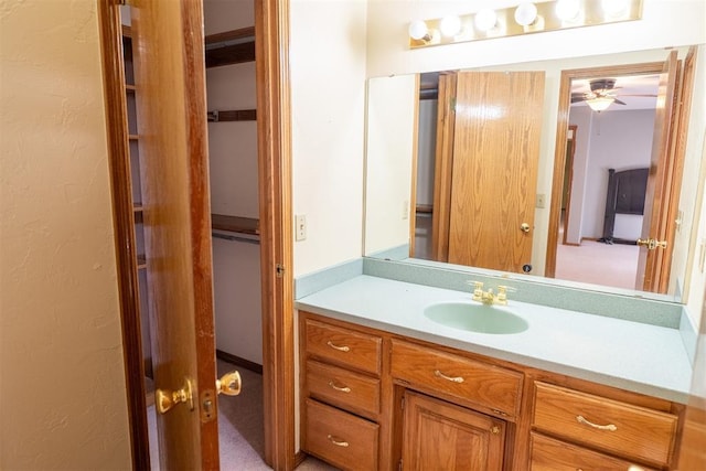 bathroom with a textured wall and vanity