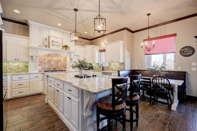 kitchen featuring dark wood finished floors, white cabinetry, and a sink