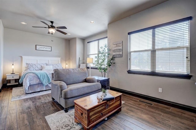 bedroom with visible vents, baseboards, and hardwood / wood-style floors