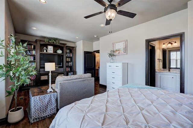 bedroom featuring a sink, wood finished floors, connected bathroom, and recessed lighting