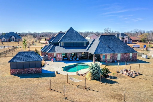 pool featuring a yard, a patio area, and fence