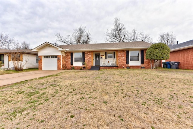 ranch-style house featuring a front yard, concrete driveway, brick siding, and an attached garage