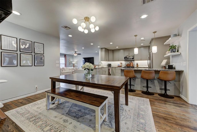 dining area featuring baseboards, visible vents, dark wood-style flooring, and recessed lighting