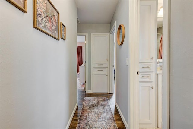 hall featuring dark wood finished floors and baseboards