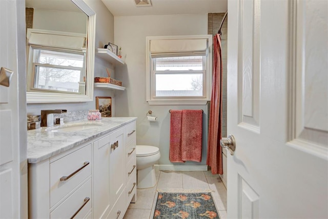 bathroom with visible vents, toilet, vanity, a shower with curtain, and tile patterned floors