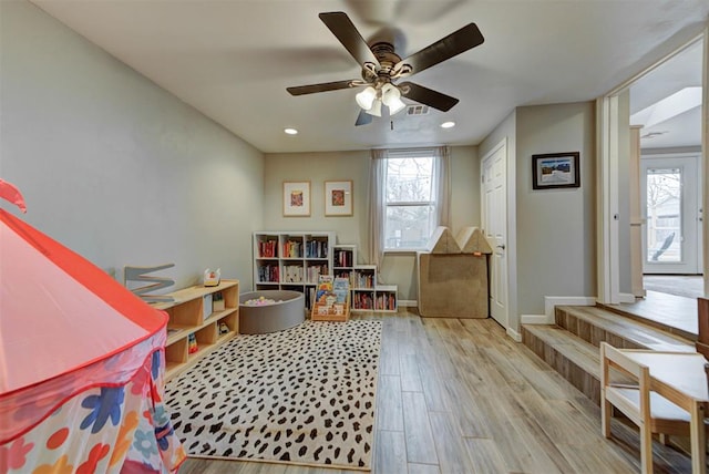 playroom featuring visible vents, wood finished floors, a wealth of natural light, and baseboards