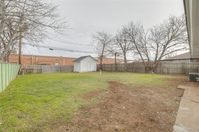 view of yard with an outbuilding, a storage unit, central AC unit, and a fenced backyard