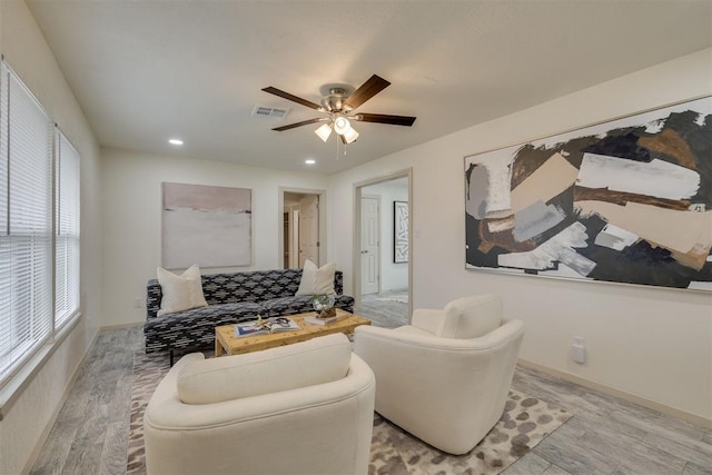 living area with a ceiling fan, recessed lighting, visible vents, and light wood-style floors