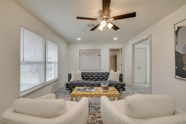 living area with baseboards, recessed lighting, visible vents, and a ceiling fan