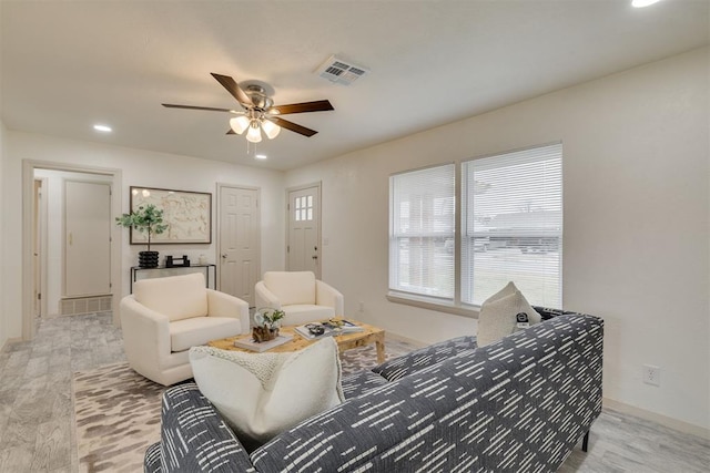 living room with baseboards, visible vents, a ceiling fan, and recessed lighting