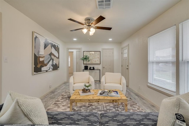 living room featuring recessed lighting, wood finished floors, visible vents, baseboards, and a ceiling fan