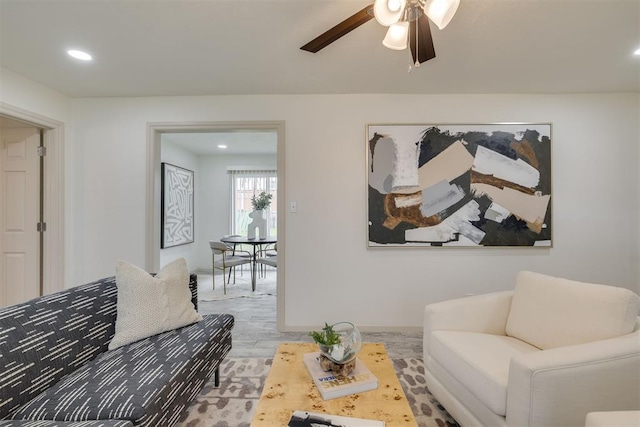 living room with a ceiling fan, recessed lighting, baseboards, and wood finished floors