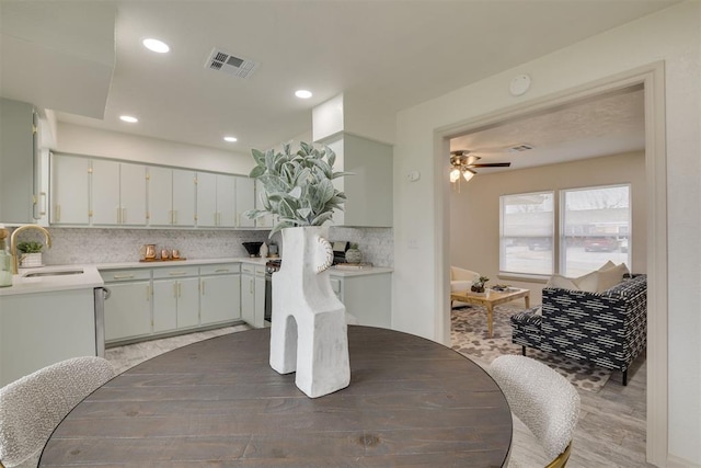 dining space with a ceiling fan, recessed lighting, visible vents, and wood finished floors