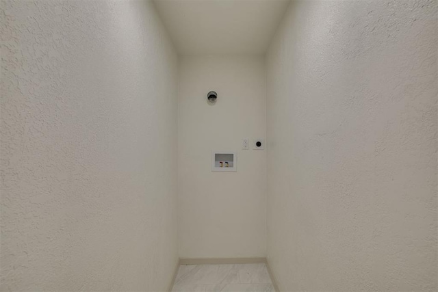 laundry area featuring a textured wall, hookup for a washing machine, and hookup for an electric dryer