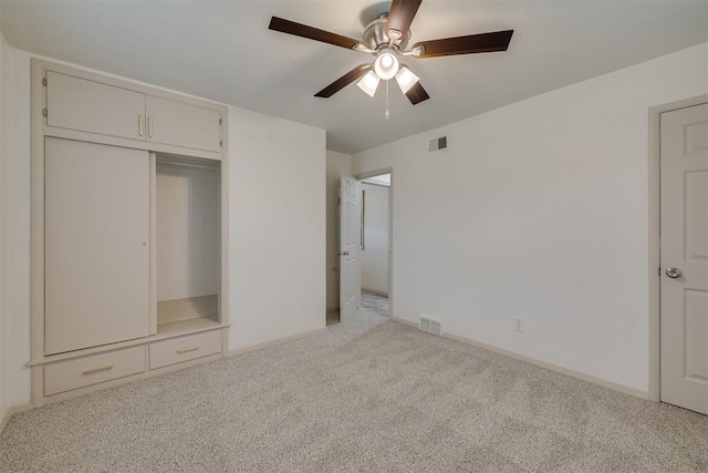 unfurnished bedroom with light carpet, ceiling fan, visible vents, and baseboards