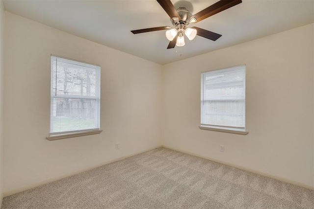 empty room with ceiling fan and light colored carpet