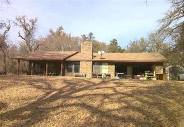 back of house with a chimney