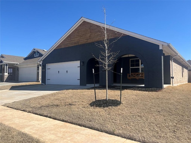 ranch-style house featuring a garage, concrete driveway, and brick siding