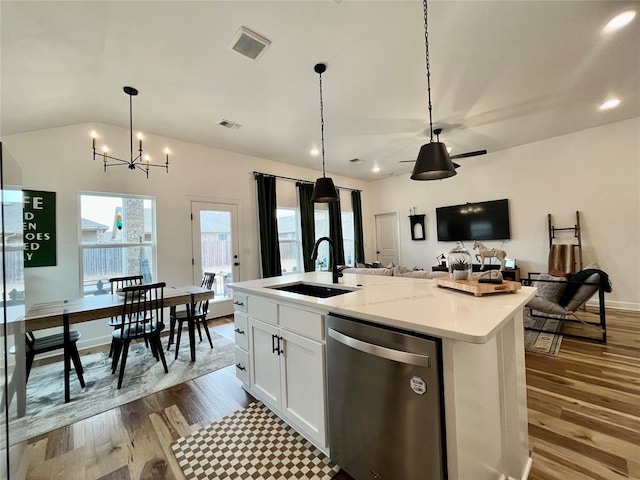 kitchen with open floor plan, visible vents, dishwasher, and a sink