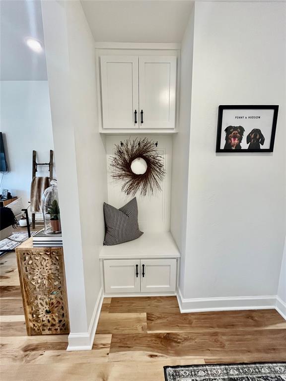 mudroom featuring light wood-type flooring and baseboards