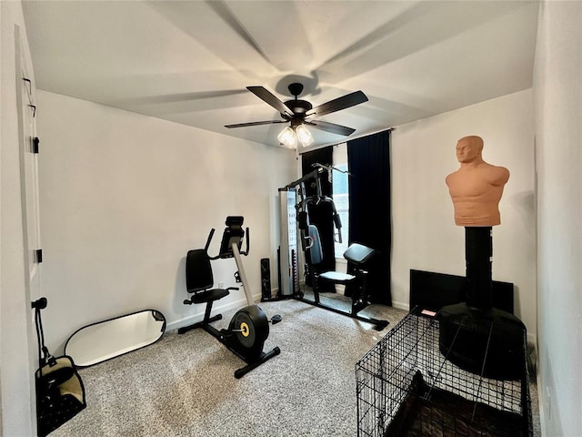 exercise room featuring a ceiling fan and baseboards