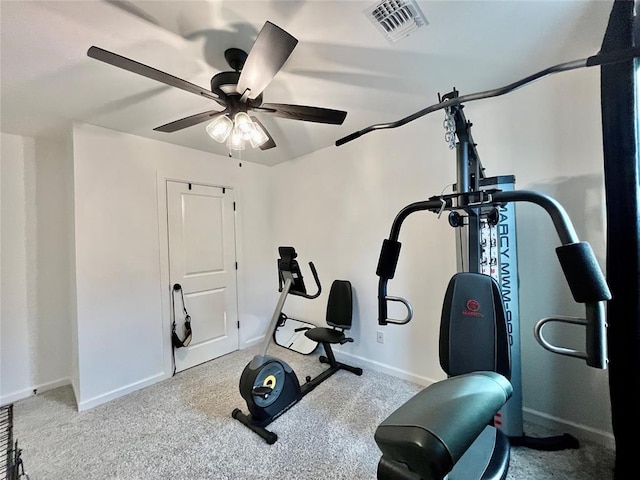 workout area featuring carpet, baseboards, visible vents, and ceiling fan